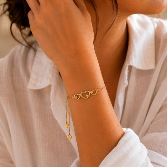 Goldmasons triple hearts gold bracelet worn on the wrist