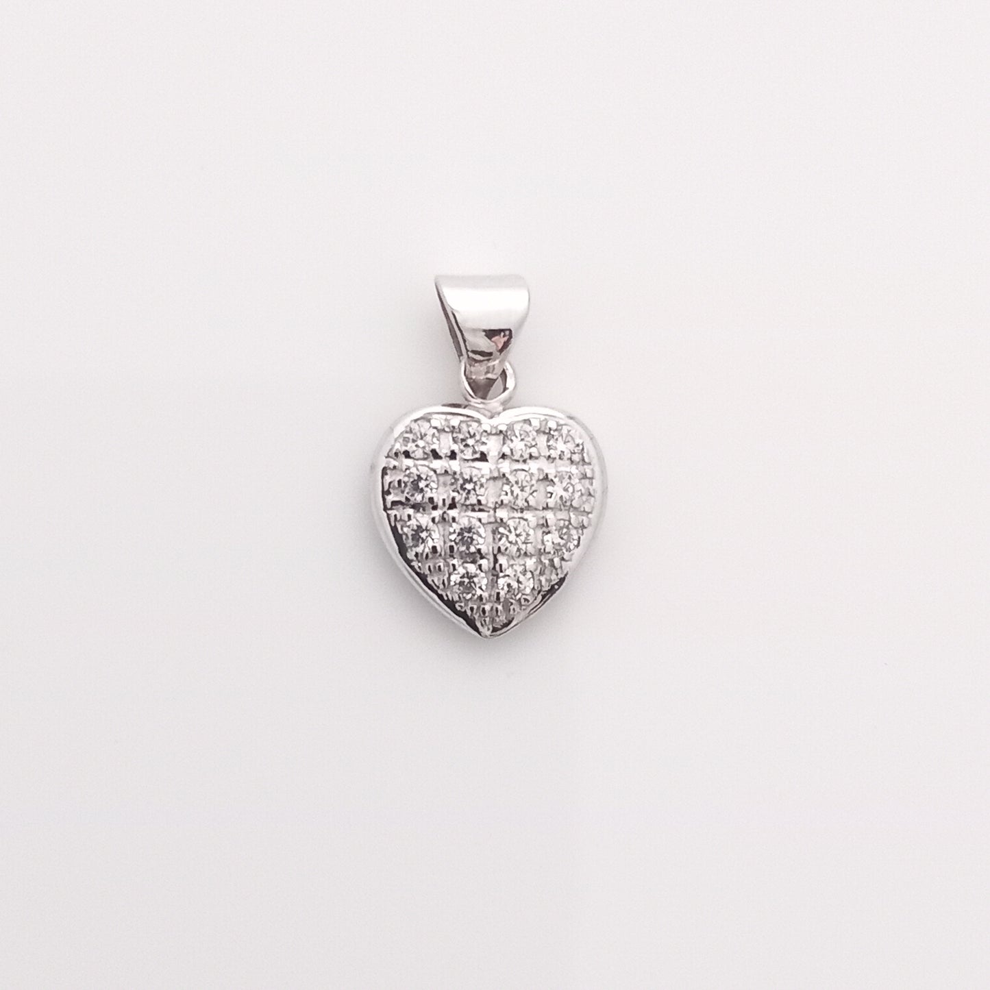 Closeup of Heart-Shaped Silver Pendant with CZ Stones