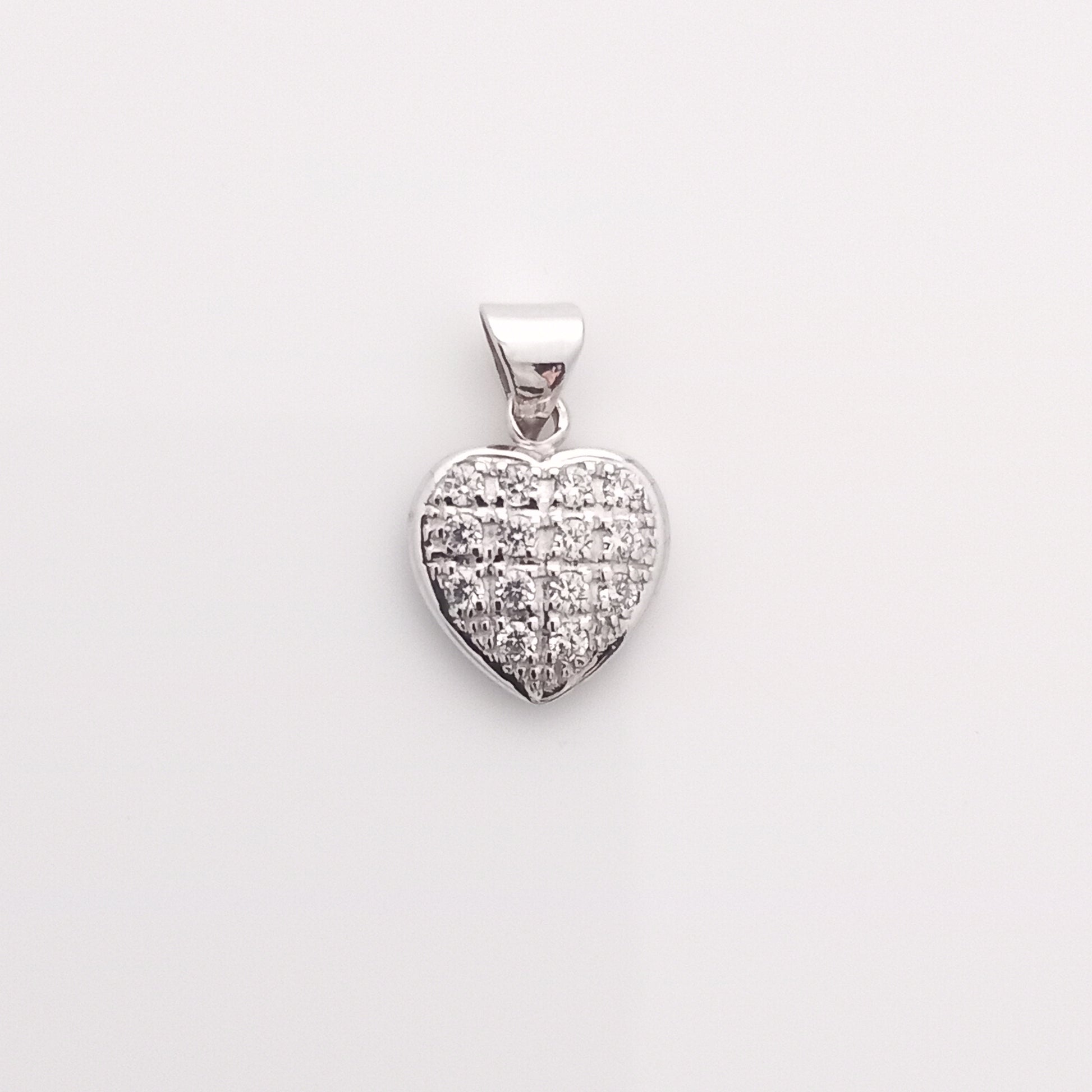 Closeup of Heart-Shaped Silver Pendant with CZ Stones