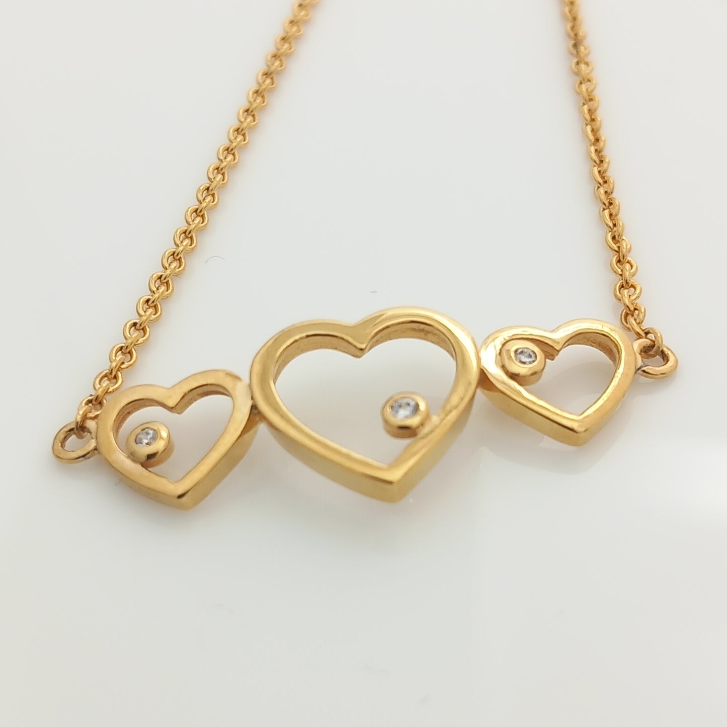 Closeup of Triple Heart Gold Chain Bracelet