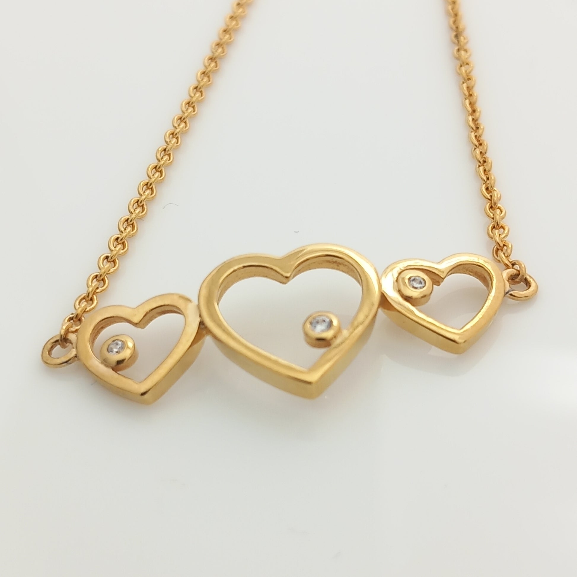 Closeup of Triple Heart Gold Chain Bracelet